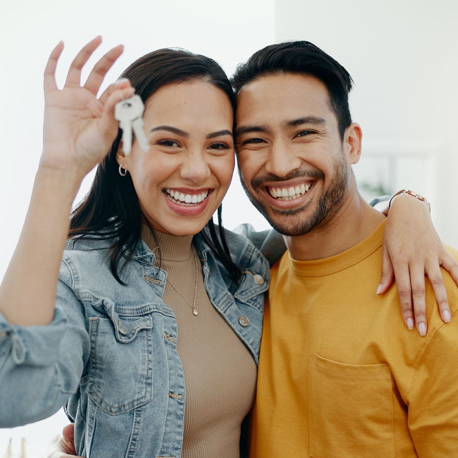 smiling-couple-moving-into-new-home